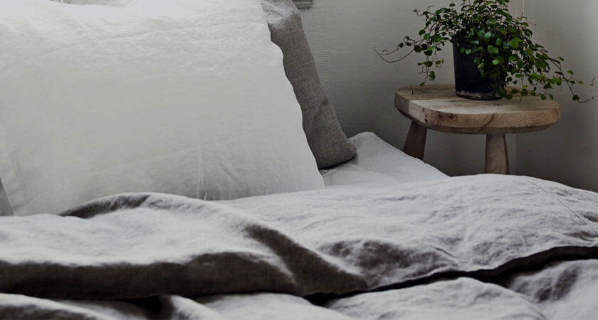 grey bed with bedside table