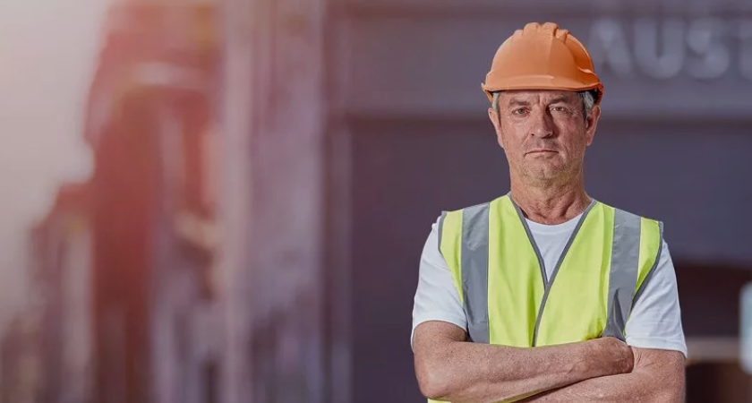 Construction worker wearing orange hard hat