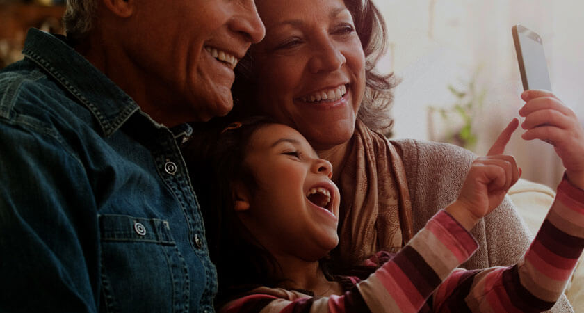 Family laughing at content on a phone